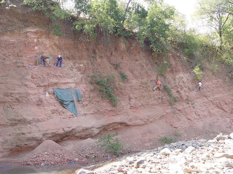The team at work along the cliff wall in 2007, at the East African Rift System in Tanzania.